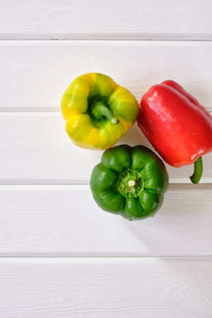 Fresh sweet pepper with water drops on white wooden table close-upの写真素材