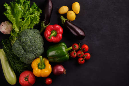 Tasty and healthy food. Fresh and juicy multicolored vegetables on a black background close-up
