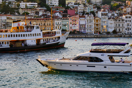 Turkey, Istanbul, Arnavutkoy - 14 Jule 2021. The coast of the Bosphorus, yachts and motor boats, colorful old wooden houses. Famous old district of Istanbul, a popular tourist destination. Place of walksのeditorial素材