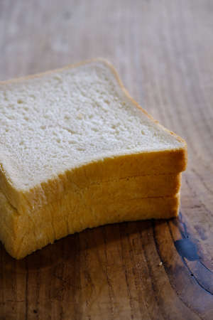 Fresh white toaster bread on an old wooden board