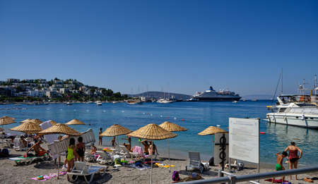 Boats and yachts on the pier. Tourists walk along the embankment of the resort town of Bodrum. Bodrum Turkey July 12, 2022. View of Marinaの写真素材