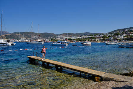 Boats and yachts on the pier. Tourists walk along the embankment of the resort town of Bodrum. Bodrum Turkey July 12, 2022. View of Marinaの写真素材