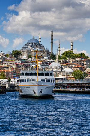 Istanbul, Turkey - July 19, 2022, Pier Eminonia and the European part of the city, view of the mosque of Suleimania, Galata Bridge and Bosphorus Strait. Old buildings with hotels and restaurants in the historical center of the city. Ferries with passengerのeditorial素材