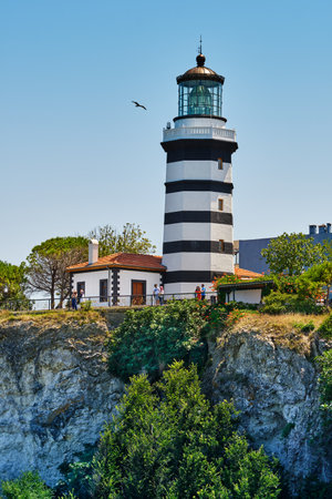 Istanbul, Turkey - July 20, 2022, Sile, The main attraction of the city is an old lighthouse on the Black Sea, tourists walk near the lighthouseのeditorial素材