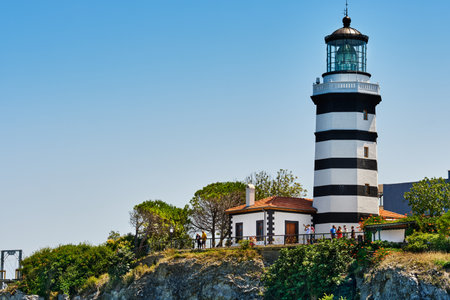 Istanbul, Turkey - July 20, 2022, Sile, The main attraction of the city is an old lighthouse on the Black Sea, tourists walk near the lighthouseのeditorial素材