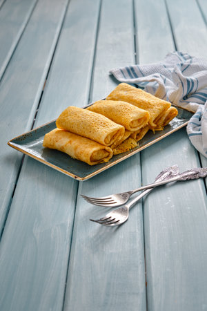 Fresh pancakes with cottage cheese and black coffee on a blue wooden tableの写真素材