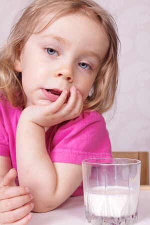 Young girl drinking milkの写真素材