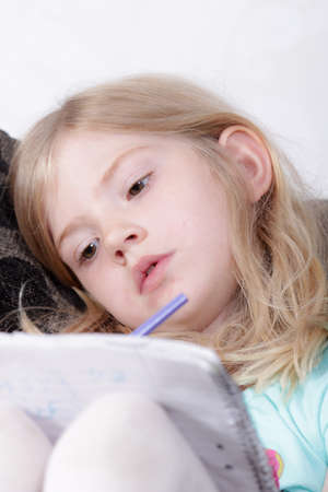 Young girl doing her homeworkの写真素材