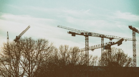 panoramic view to construction site with cranes