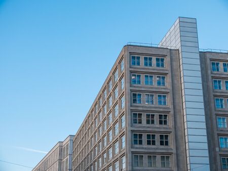 Low Angle Architectural Exterior View of Generic Low Rise Building with Stone Facade and Windows and...
