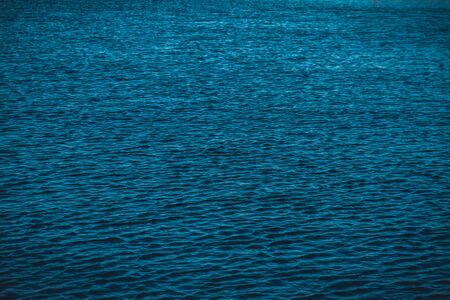 Empty aquatic background of rippled blue ocean surfaceの写真素材