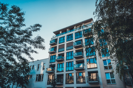 modern house with some glass balcony and trees on both sidesの写真素材