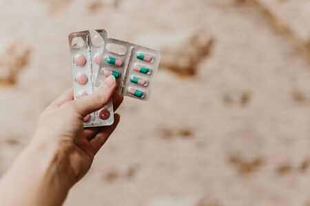 Pink and green in the hands of man.Medicines in the hospital. Medicines in the hospital. Treatment of coronavirus.Heart.Instrument of the doctor.Healthy lifestyle, vitamins, vaccination,の写真素材