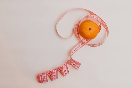 Orange isolated on white background.Tape measure.Food supplies crisis food stock for quarantine...