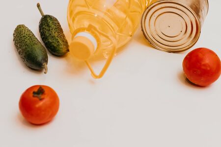 cucumbers, tomatoes, vegetable oil, eggs and canned goods isolated on white background.Food supplies crisis food stock for quarantine.Food delivery, Donation, coronavirus.Tape measure.の写真素材