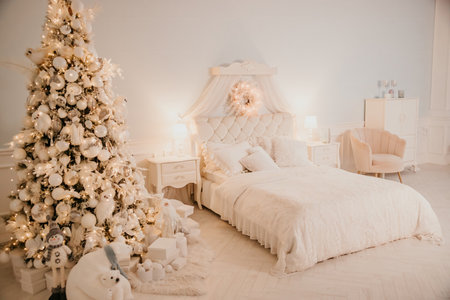 Modern New Years decor for the living room and bedroom. Christmas tree, decorated with New Years toys, stands near the fireplaceの写真素材