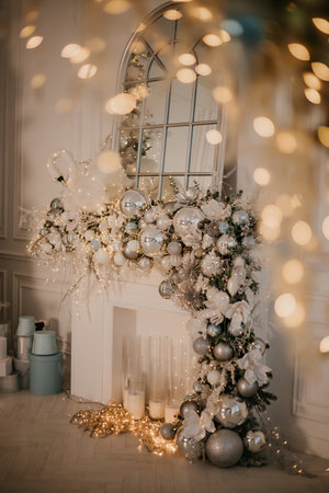 Modern New Year's decor for the living room and bedroom. Christmas tree, decorated with New Year's toys, stands near the fireplace. High quality photoの写真素材