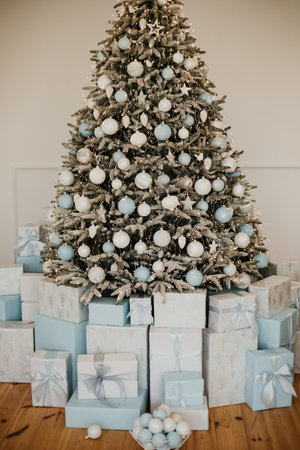 Christmas decorations lights. Modern New Years decor. Christmas trees with garlands and gifts.の写真素材