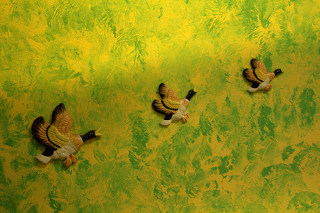 1940's 1950's hanging plaster ducks on yellow and green painted wall.の写真素材