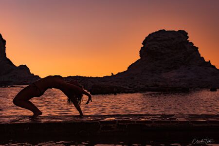 Yoga position of young girl on Passetto beachの写真素材