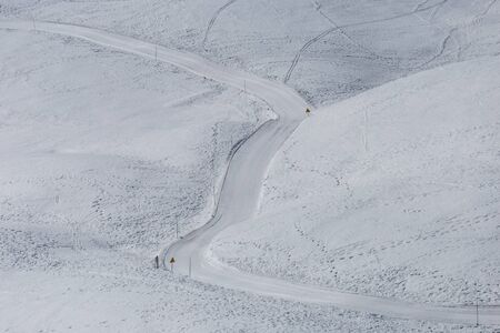 Road lost in a snowy wastelandの写真素材