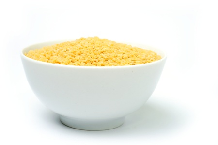 An image of raw yellow pasta in a bowl