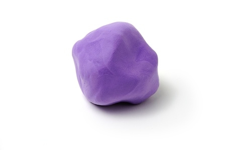 An image of a piece of purple plasticine on white background