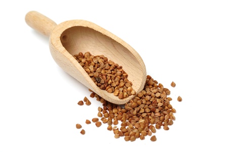 An image of buckwheat in a wooden scoopの写真素材
