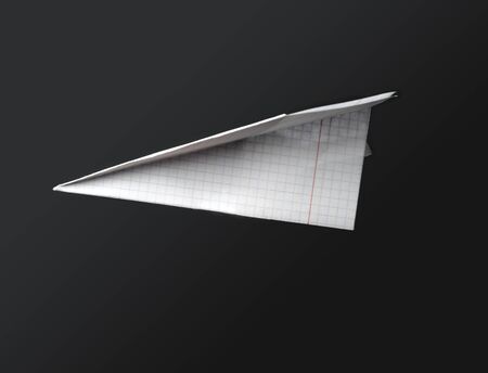 An image of paper airplane on dark backgroundの写真素材