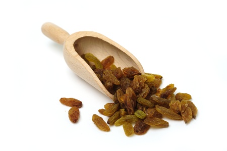 An image of raw brown raisins in a scoopの写真素材
