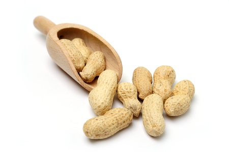 An image of peanuts in a wooden scoopの写真素材