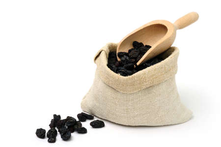 An image of sweet raisins in a textile sack and a scoopの写真素材