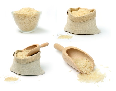 A srt of raw rice in a burlap sack and cupの写真素材