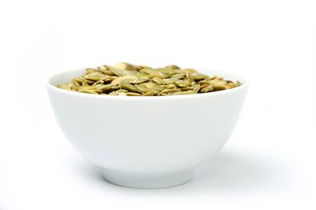 An image of a white bowl with pumpkin seedsの写真素材