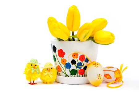 Yellow chickens with tulips in ceramic pot and eggsの写真素材