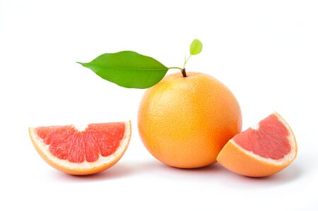 Ripe grapefruit with leaves and slices on whiteの写真素材