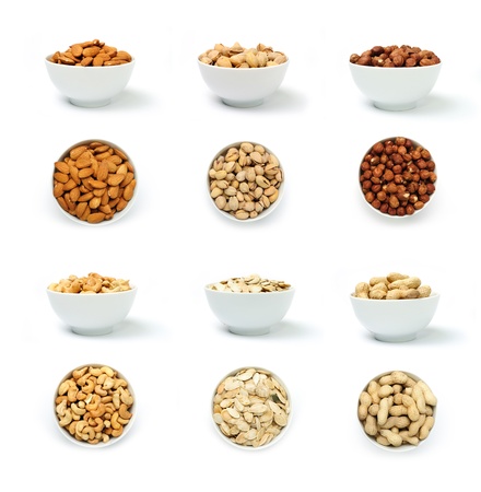 An image of a set of nuts in white bowlsの写真素材