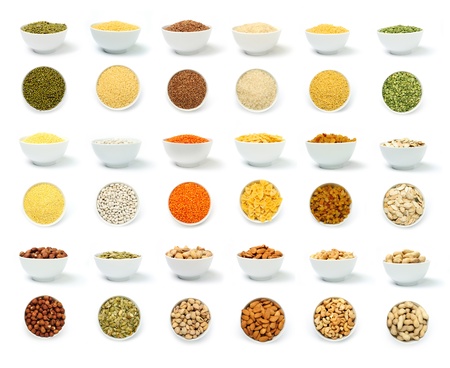 An image of a set of groats and nuts in white bowlsの写真素材