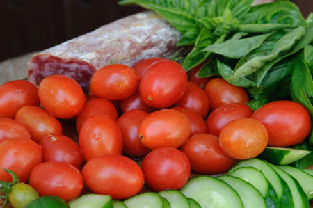 An image of tomatoes, cucumbers, sausage and basilの写真素材
