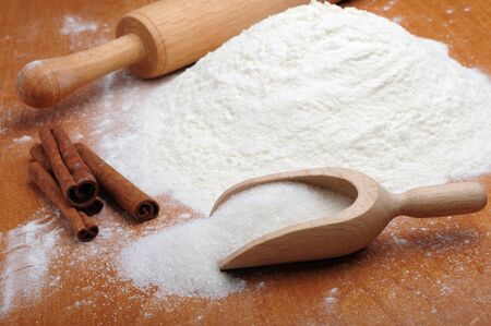 An image of flour, sugar and cinnamon sticksの写真素材