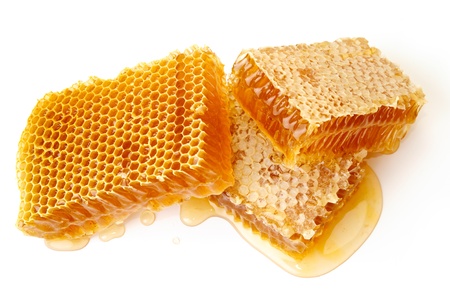 Yellow honeycomb wax cell detail slice on white backgroundの写真素材