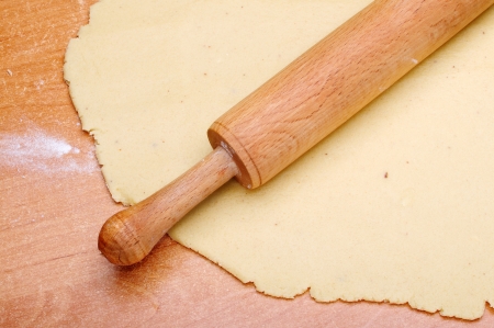 A wooden rolling pin on the doughの写真素材