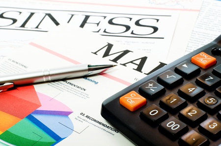 Pen on the investment chart with calculatorの写真素材