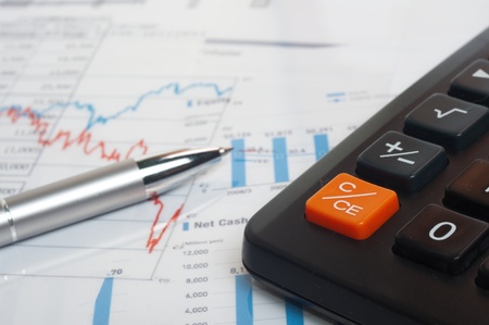 An image of pen on financial newspaper with stock market graphicsの写真素材