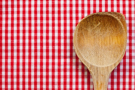 Antique wooden spoon for cooking with red white backgroundの写真素材