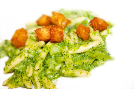 Fresh handmade pasta with pesto and croutonsの写真素材