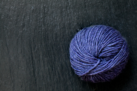 skein of yarn purple with black slate backgroundの写真素材