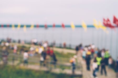 People strolling at rivers bank during summer festival