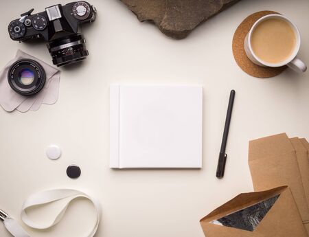 Front square book cover template with photo accessories and cup of coffee on white backgroundの写真素材