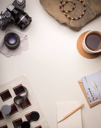 Vertical template with retro camera, old film rolls, postcard and coffeeの写真素材
